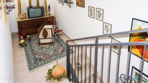 an overhead view of a living room with a television and a staircase at Agriturismo Costa San Bernardo in Vaglio di Basilicata