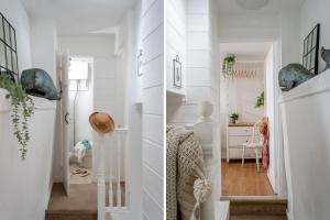 a home with white walls and a hallway at Anchor Cottage in Dartmouth