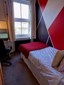 a bedroom with a bed and a window at The Nook Cosby Village 