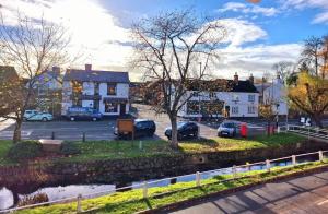 a city with cars parked in a parking lot at The Nook Cosby Village 