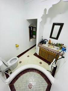a bathroom with a toilet and a sink at Archduke private rooms in Marrakech