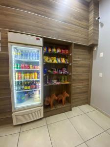 a refrigerator filled with lots of drinks in a room at Rota 232 Hotel Caruaru in Caruaru