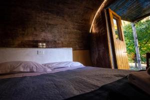 a bedroom with a large bed with a window at AgriCamping AlbaVillage Hotel & Wellness in Alba