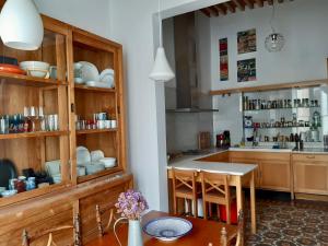 a kitchen with wooden cabinets and a table at CASA ARCO in Almería