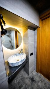 a bathroom with a sink and a mirror at Anbani Apartments - City Center in Tbilisi City
