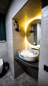 a bathroom with a large marble tub on a counter at Anbani Apartments - City Center in Tbilisi City