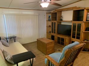 a living room with a television and a table and chairs at Edgewater Getaway in Port Lavaca