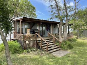 a small house with a porch and stairs to it at Edgewater Getaway in Port Lavaca