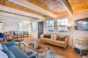 a living room with a couch and a table at Dreamy Big Bear Home with Wood Stove and Grill in Big Bear Lake