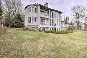 a large house on top of a grass field at Grand Egg Harbor Home with Stunning Lake Views! in Egg Harbor