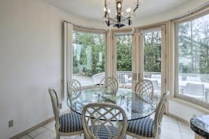 a dining room with a glass table and chairs at Grand Egg Harbor Home with Stunning Lake Views! in Egg Harbor