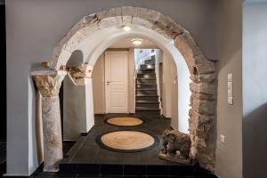 a hallway with an archway in a house at The Hadrian Wall - A Historic Acropolis Villa in Athens