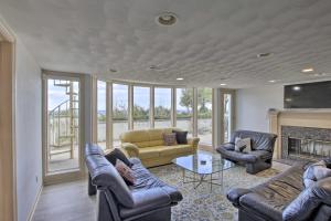 a living room with couches and a fireplace at Grand Egg Harbor Home with Stunning Lake Views! in Egg Harbor