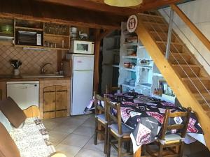 a kitchen with a table and chairs in a room at Partie de chalet in Saint-Chaffrey