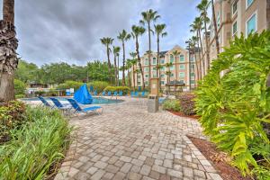 a resort with lounge chairs and a swimming pool at Orlando Family Condo about 9 Mi to Magic Kingdom! in Orlando
