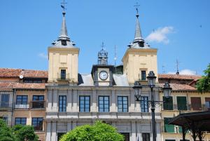 a building with a clock tower on top of it at Hotel Infanta Isabel by Recordis Hotels in Segovia