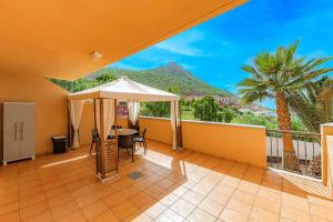 a balcony with a table and a view of a mountain at 2-bed AMAZING OCEAN VIEW APARTMENT Costa Adeje in Adeje