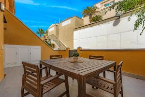 a wooden table and chairs on a patio at 2-bed AMAZING OCEAN VIEW APARTMENT Costa Adeje in Adeje