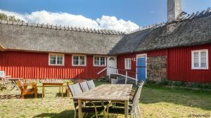 a red building with a table in front of it at Apelviksgården B&B in Varberg