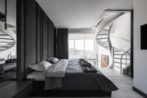 A bed or beds in a room at The Penthouse Kyiv