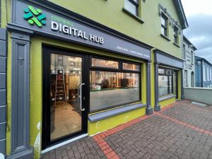 a storefront of a digital hub with glass doors at Top of the Town No.5 in Cootehill