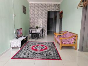 a living room with a couch and a rug at Homestay Pekan Pahang in Pekan