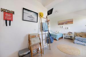 a living room with a painting on the wall and a table at The Studio - Pet friendly in Alvor