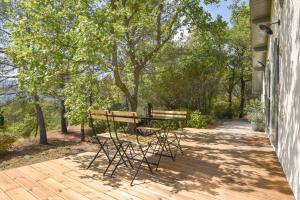 a wooden deck with a bench and a table at Cottage Sylvie à 25 minutes Cassis in Roquevaire