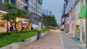 a street in a city with people walking on the sidewalk at THE TiME in Incheon