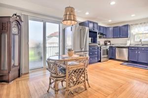 a kitchen with blue cabinets and a table at Cozy Historic Wakefield Home Close to Beaches in South Kingstown
