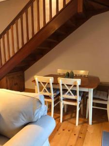 a dining room with a table and two chairs at Las Raucas in Colombres