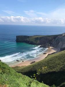 a view of a beach with the ocean at Las Raucas in Colombres