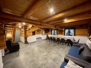 uma sala de estar com tectos em madeira e um quarto com cadeiras em Cabana din Groapa Frumoasa em Rasnov