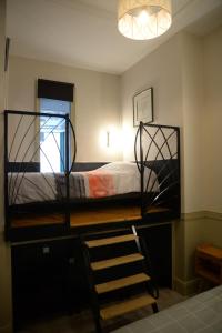 a bedroom with a bunk bed with a ladder in it at Le Stanislas, un style! in Nancy