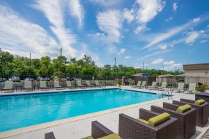 a swimming pool with chairs at Holiday Inn Express & Suites Ft. Washington - Philadelphia, an IHG Hotel in Fort Washington