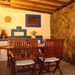 a dining room with two chairs and a table at Casa de Seixe in Odeceixe