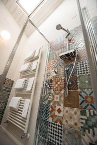 a bathroom with a shower and a mosaic floor at A Casa di BiaGio in Rapolano Terme