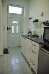 a kitchen with a white door and a counter top at Studio apartman Gajba in city center in Zagreb