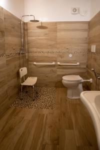 a bathroom with a toilet and a chair and a tub at Agriturismo Ponte Florio in Verona