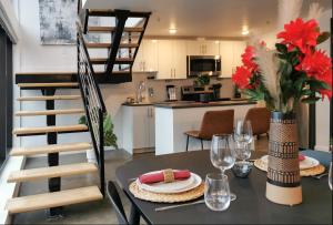 a kitchen and dining room with a table and a staircase at Cameo Hotel and Suites in Halifax