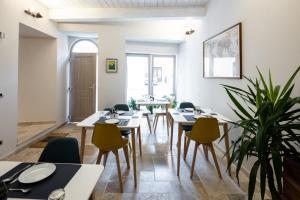 a dining room with tables and chairs and plants at A Casa di BiaGio in Rapolano Terme