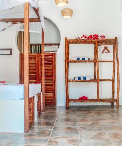 a room with wooden shelves and a tiled floor at Dhow Resort in Jambiani