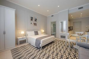 a bedroom with a bed and a table and a desk at Il Casale Normanno in San Vito dei Normanni +67 photos