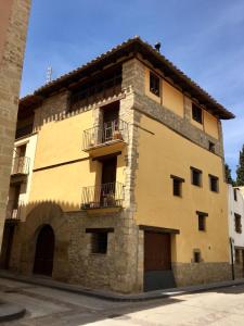 a large brick building with two balconies on it at La Casa Amarilla in Rubielos de Mora
