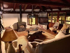 a living room with a couch and a fireplace at La Casa Amarilla in Rubielos de Mora