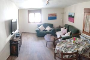 a living room with a couch and a table at La calma de Arnedillo in Arnedillo
