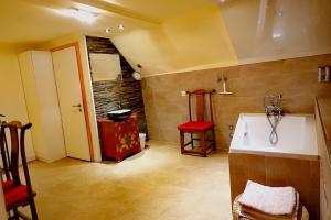 a bathroom with a white sink and a red stool at Hotel JiuDing in Hochdorf