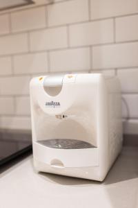a white toaster sitting on top of a counter at CASA FLORIT - The Maritim Serreria Suites in Valencia +272 photos