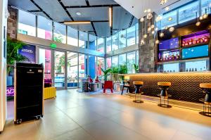 a restaurant with a bar with stools in it at High end studio yotel downtown L57 in Miami