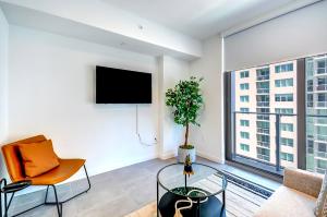 a living room with a tv and a large window at High end studio yotel downtown L57 in Miami